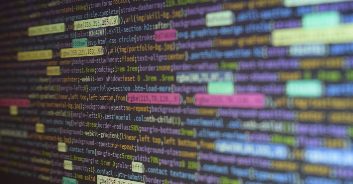 Close-up of colorful source code on a monitor, showcasing programming and technology concepts.
